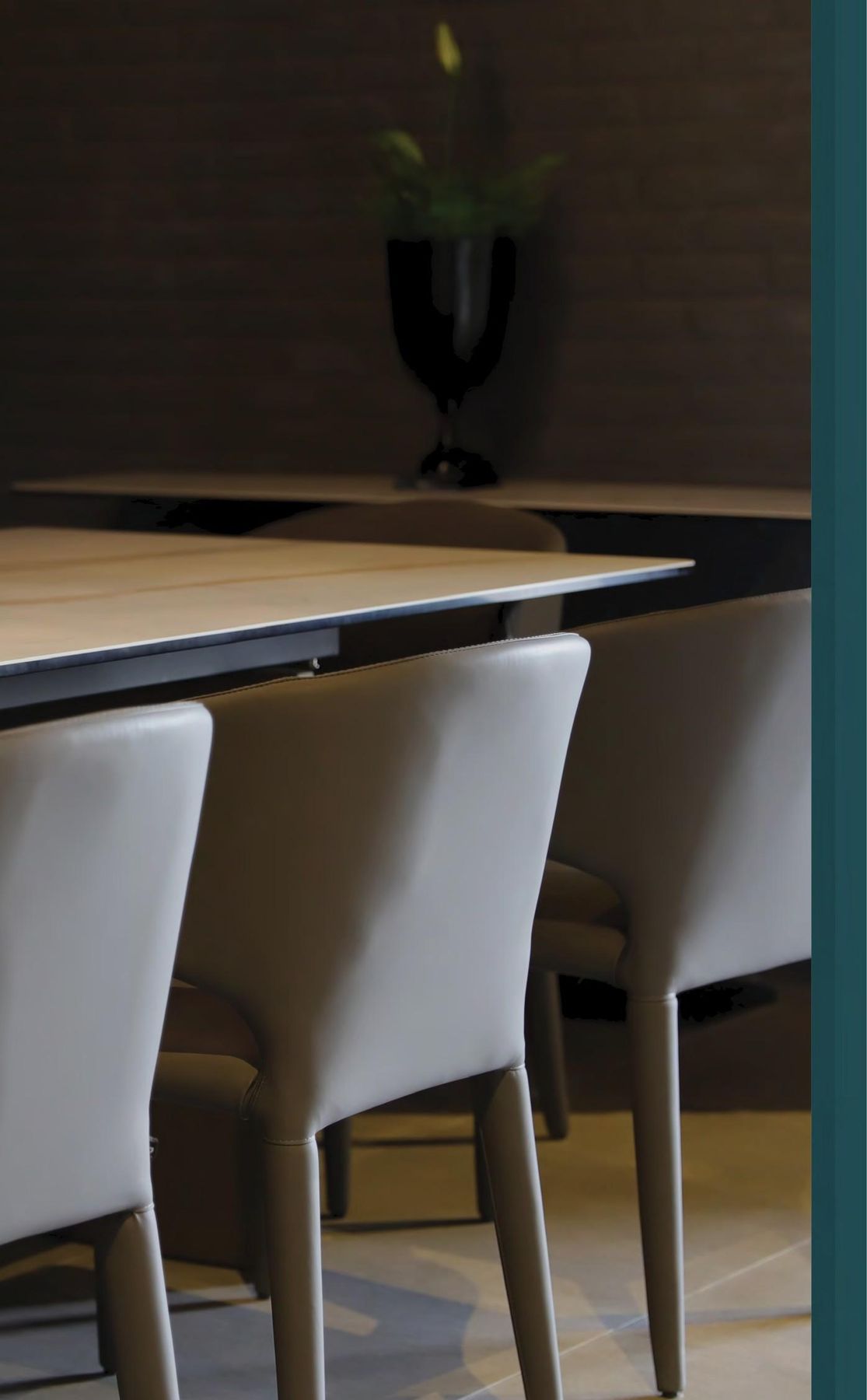 Dining area with dark wood panelling and bar stools